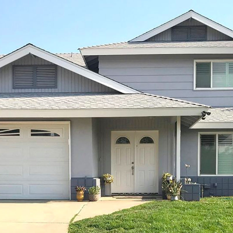 After image of Florida house with new siding and a new shingle roof.